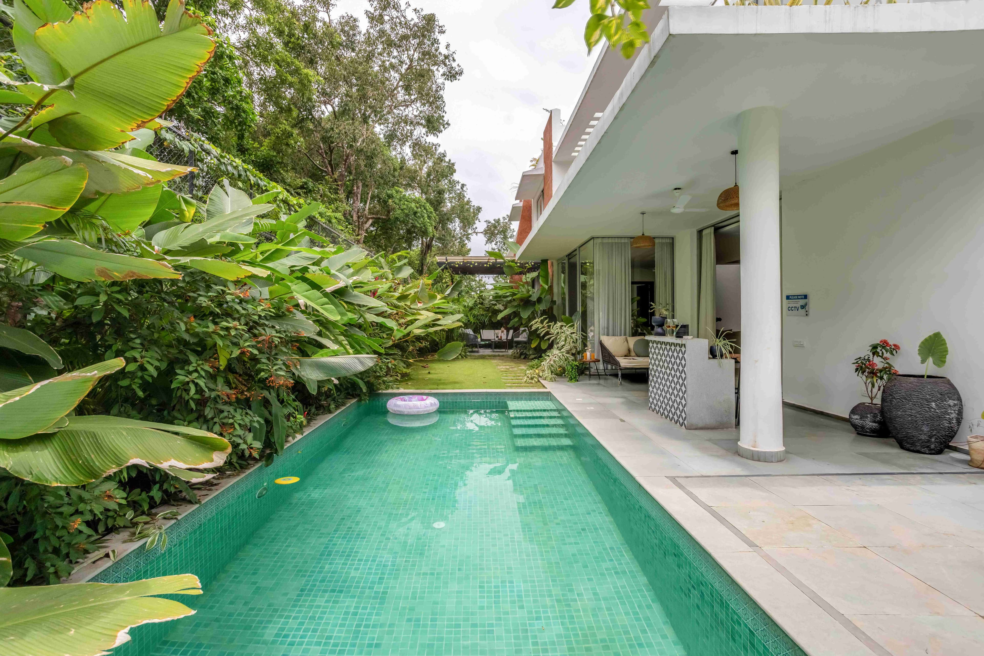 Villa 12 private swimming pool surrounded by greenery in Siolim, Goa